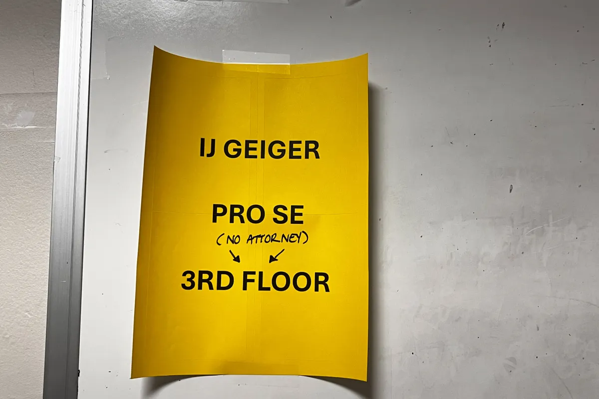 Image of yellow notice taped to a door.
